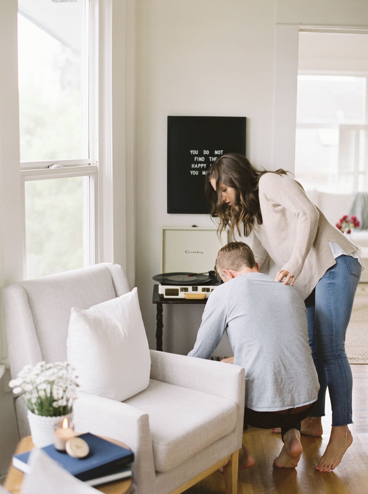 Couple enjoying music on a record player at home