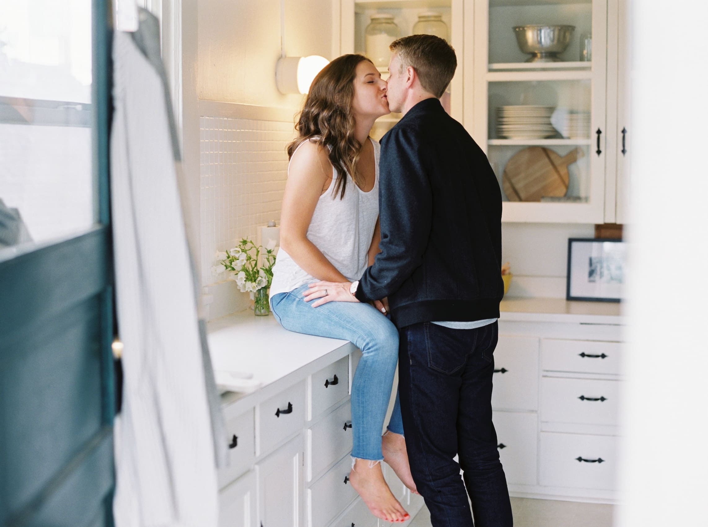 Couple sharing a romantic moment in a cozy kitchen setting
