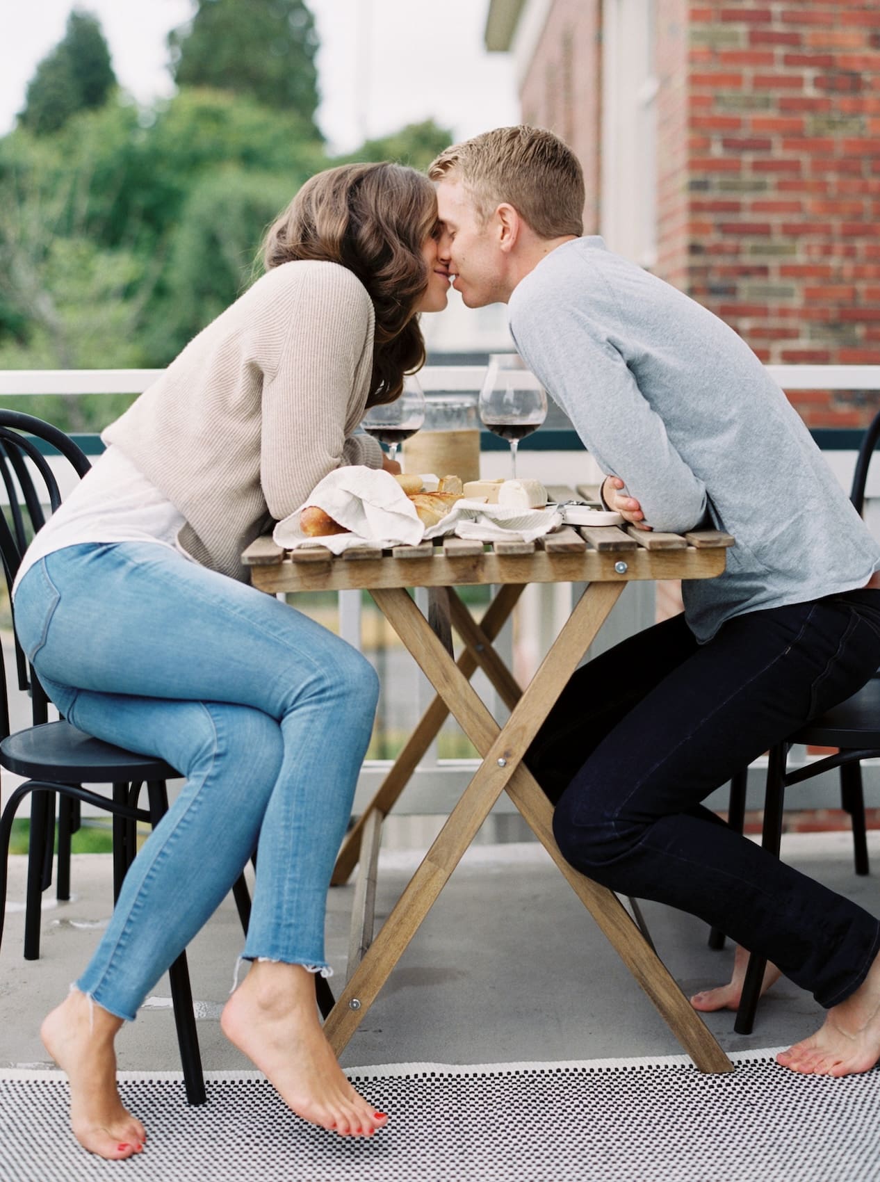 Couple sharing a romantic meal on outdoor patio table