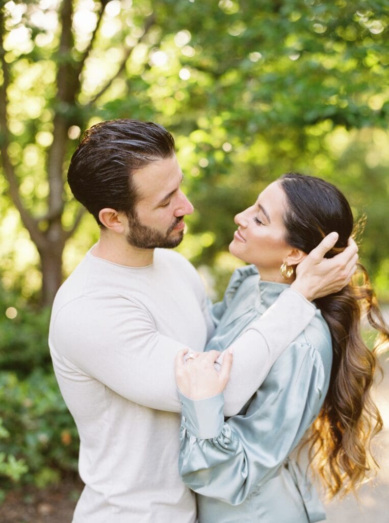 A couple shares a loving moment in a scenic outdoor setting