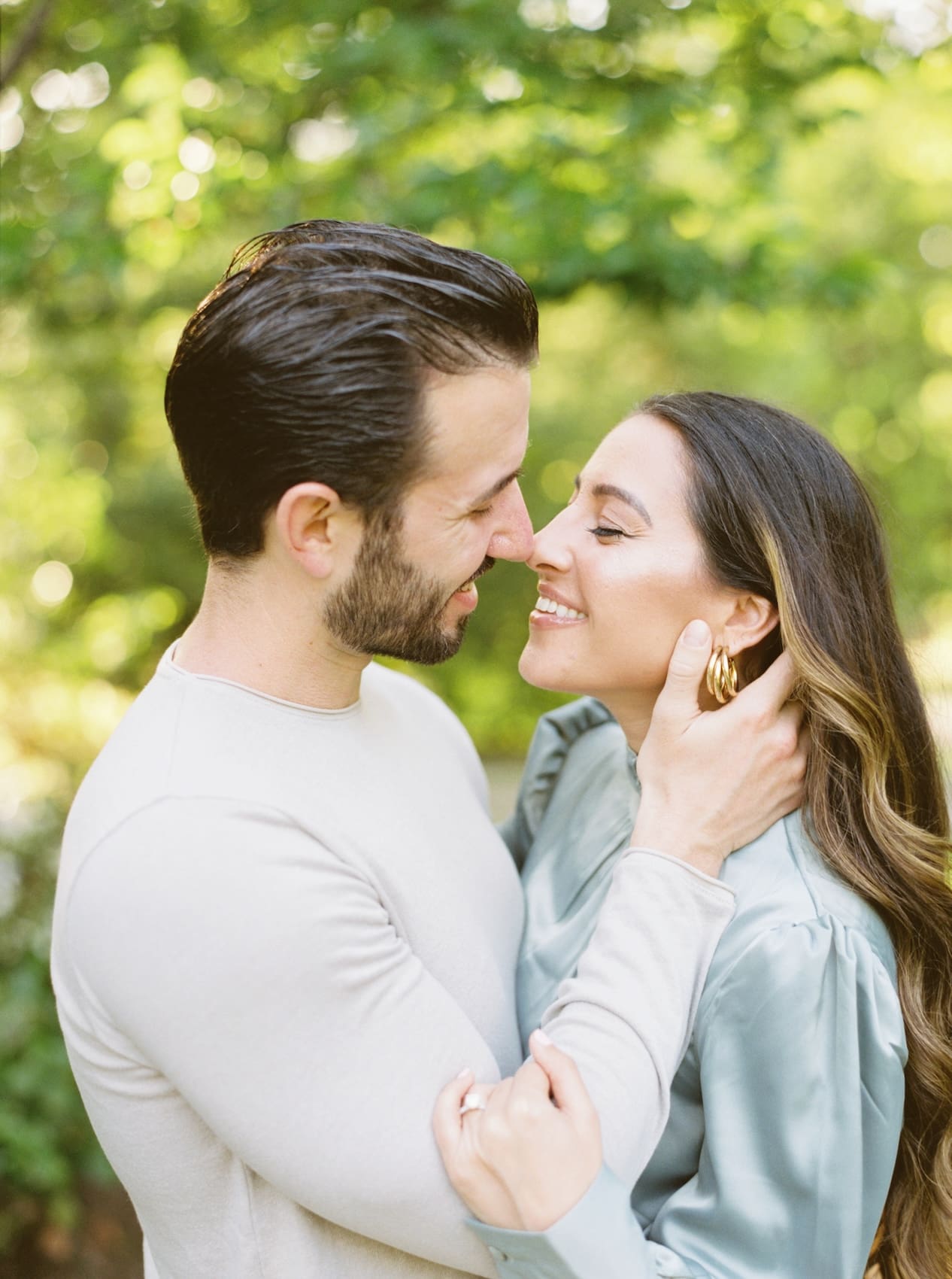 Couple sharing a loving moment in a sunny garden setting