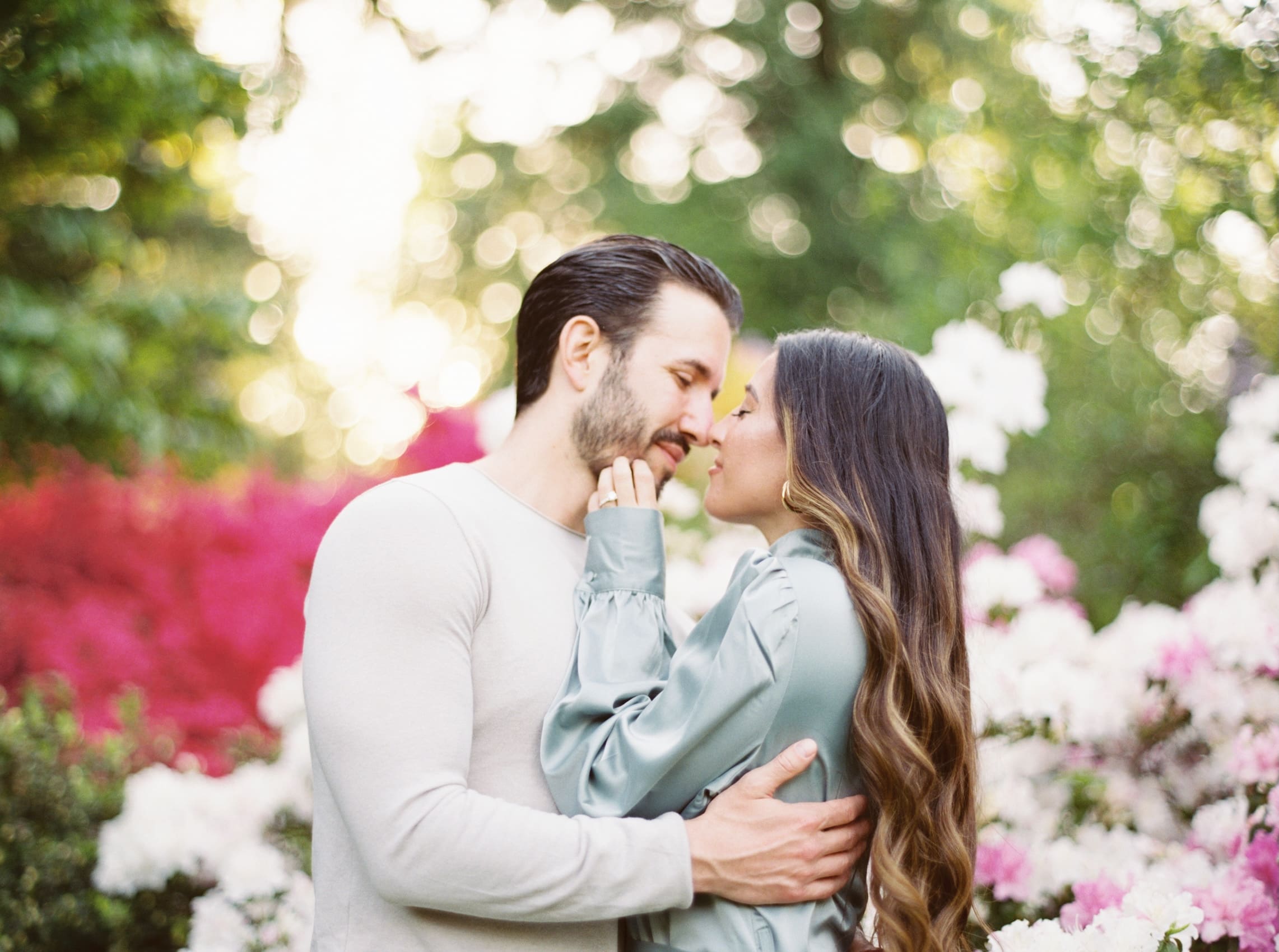 Couple sharing a romantic moment in a blossoming garden