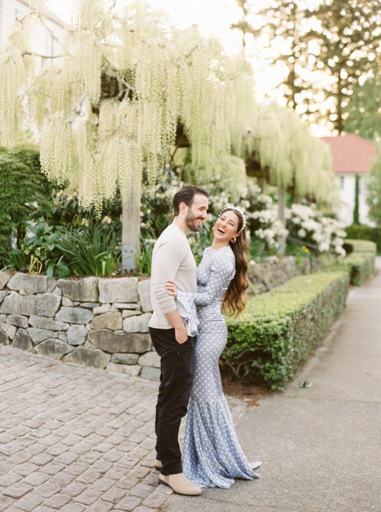 Couple laughing together in a beautiful garden setting