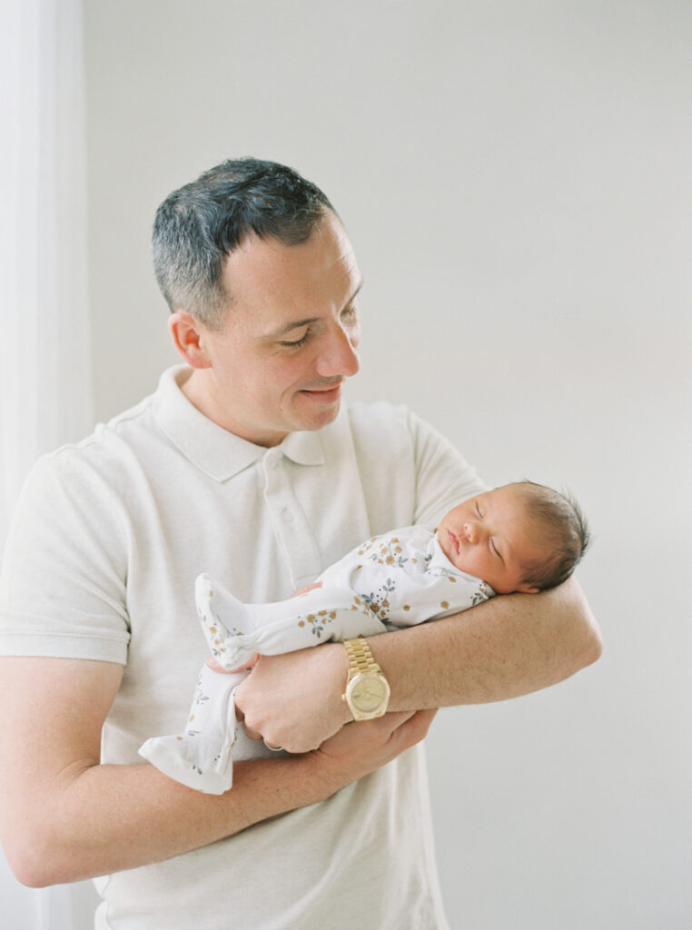 dad with newborn on film