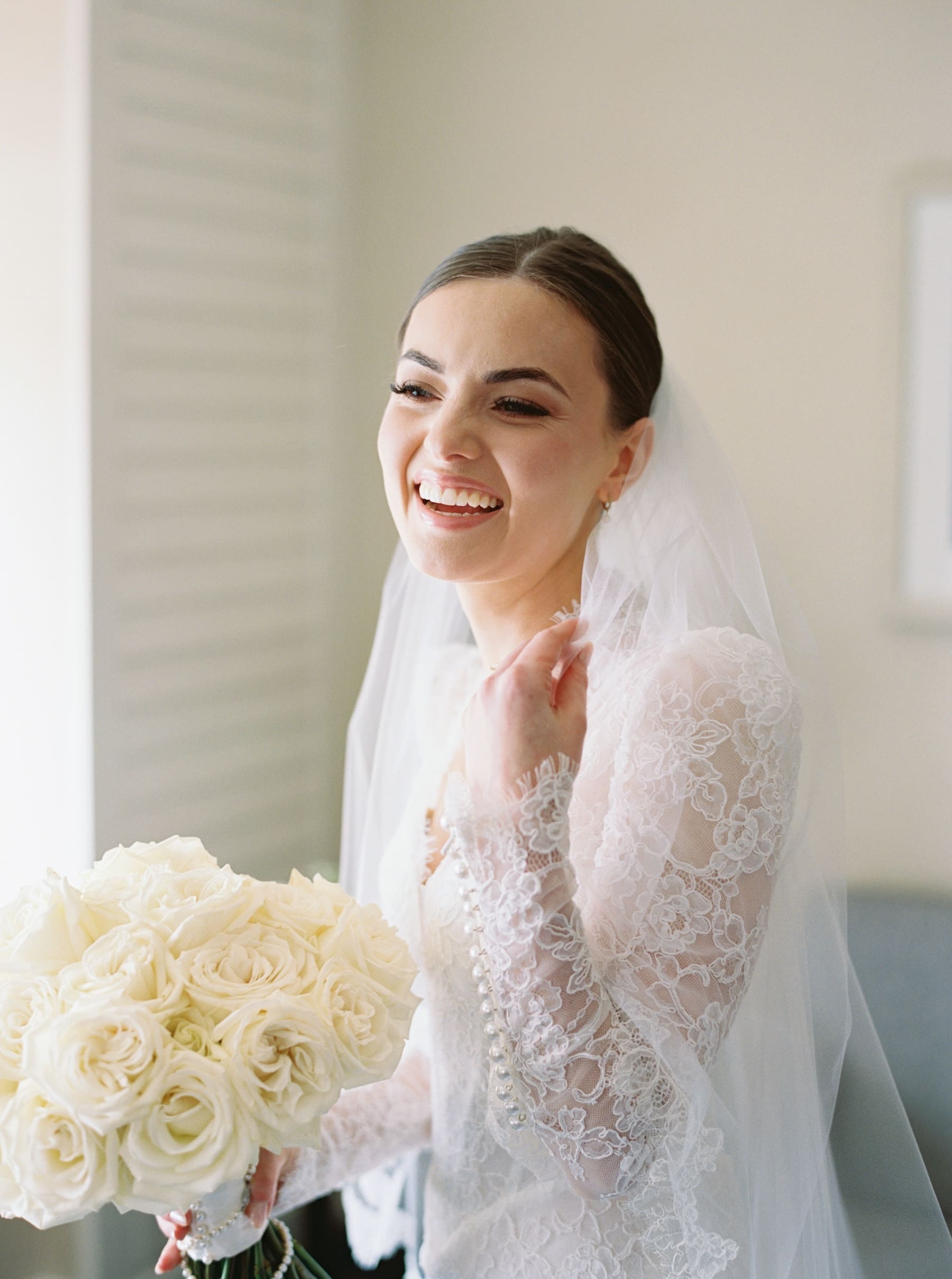 Bride smiling with bouquet at Woodmark Hotel wedding photography