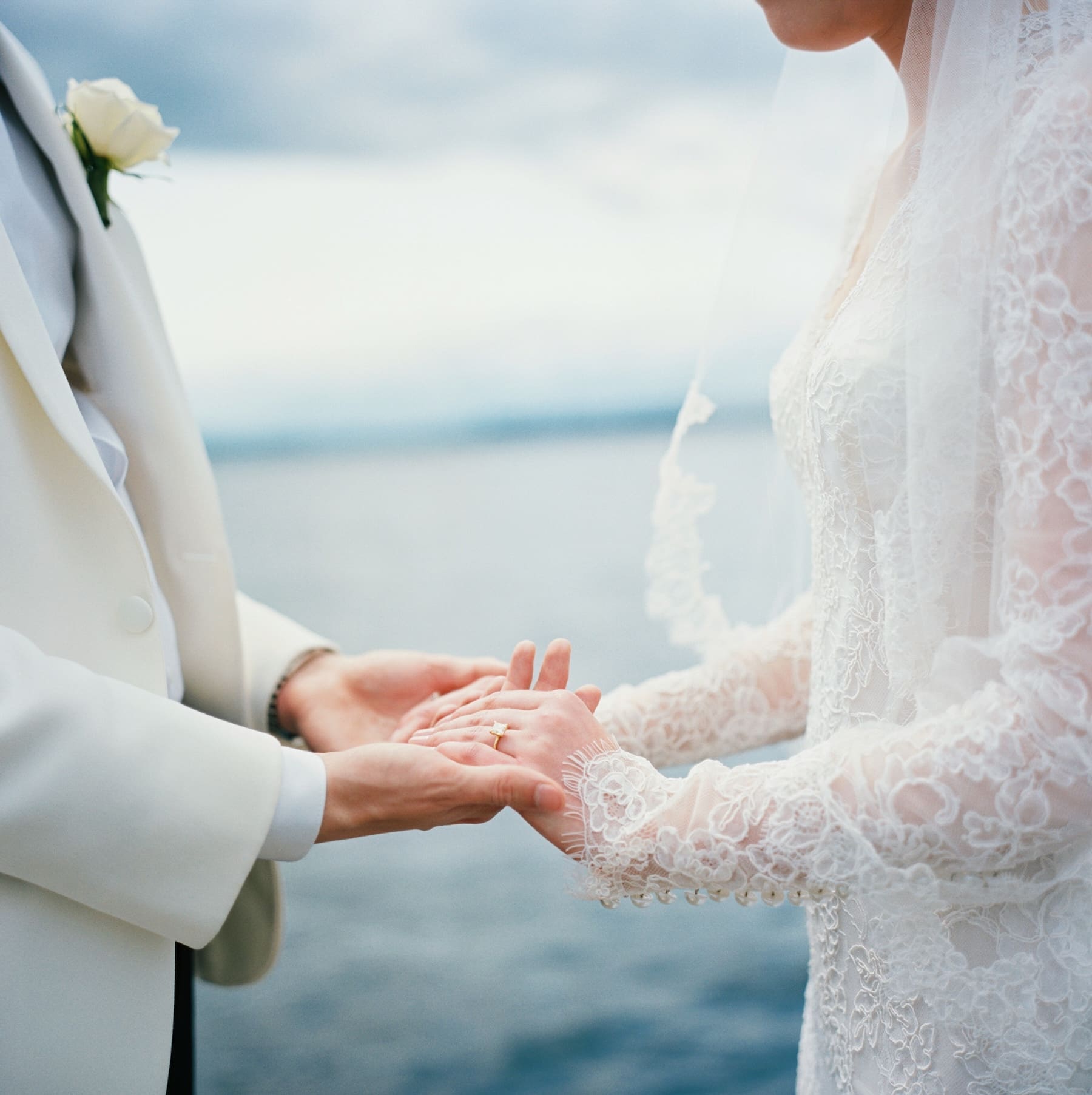 hassleblad 501c portra 400 film image of bride and groom holding hands with kirkland waterfront behind them 