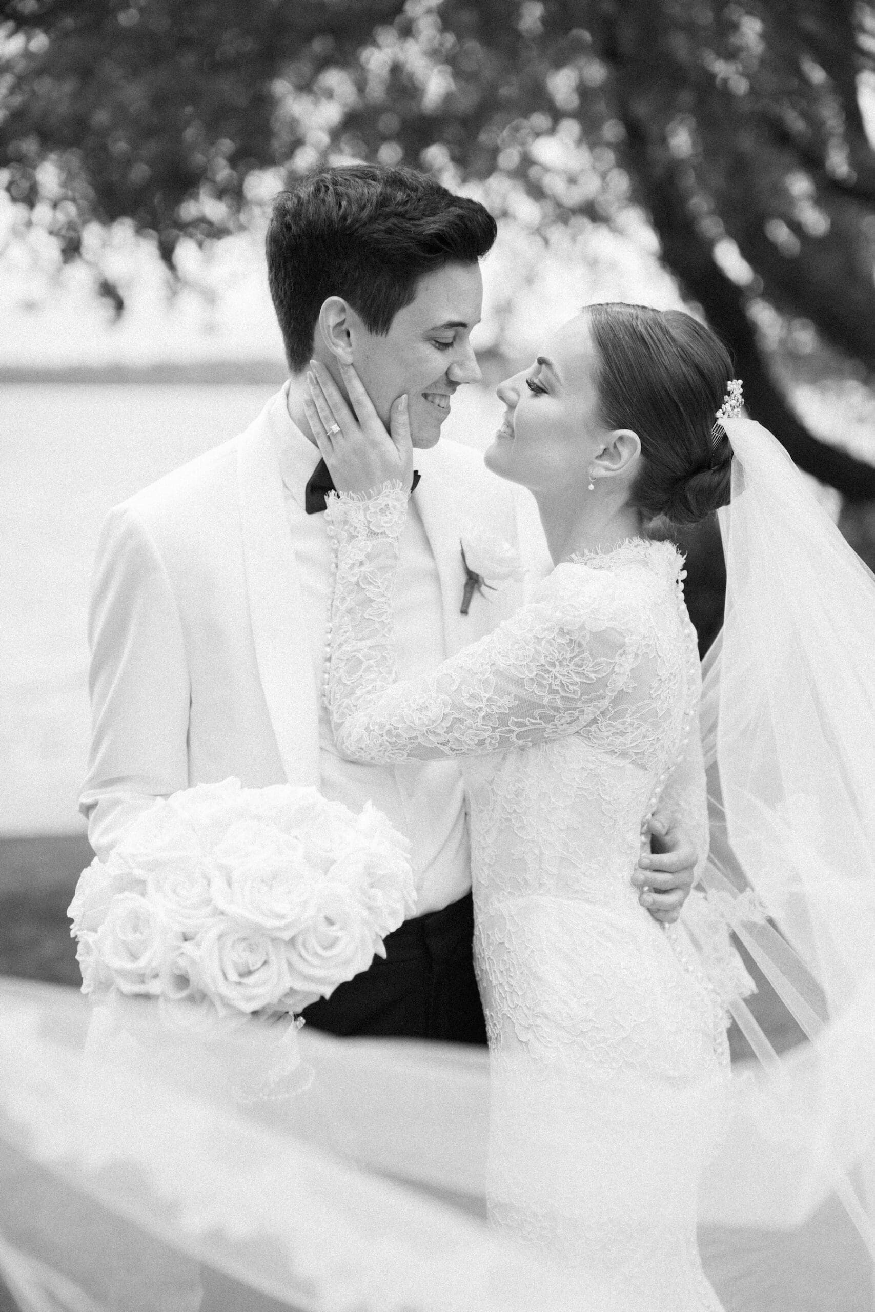 black and white film photo of bride softly touching grooms face at the woodmark hotel