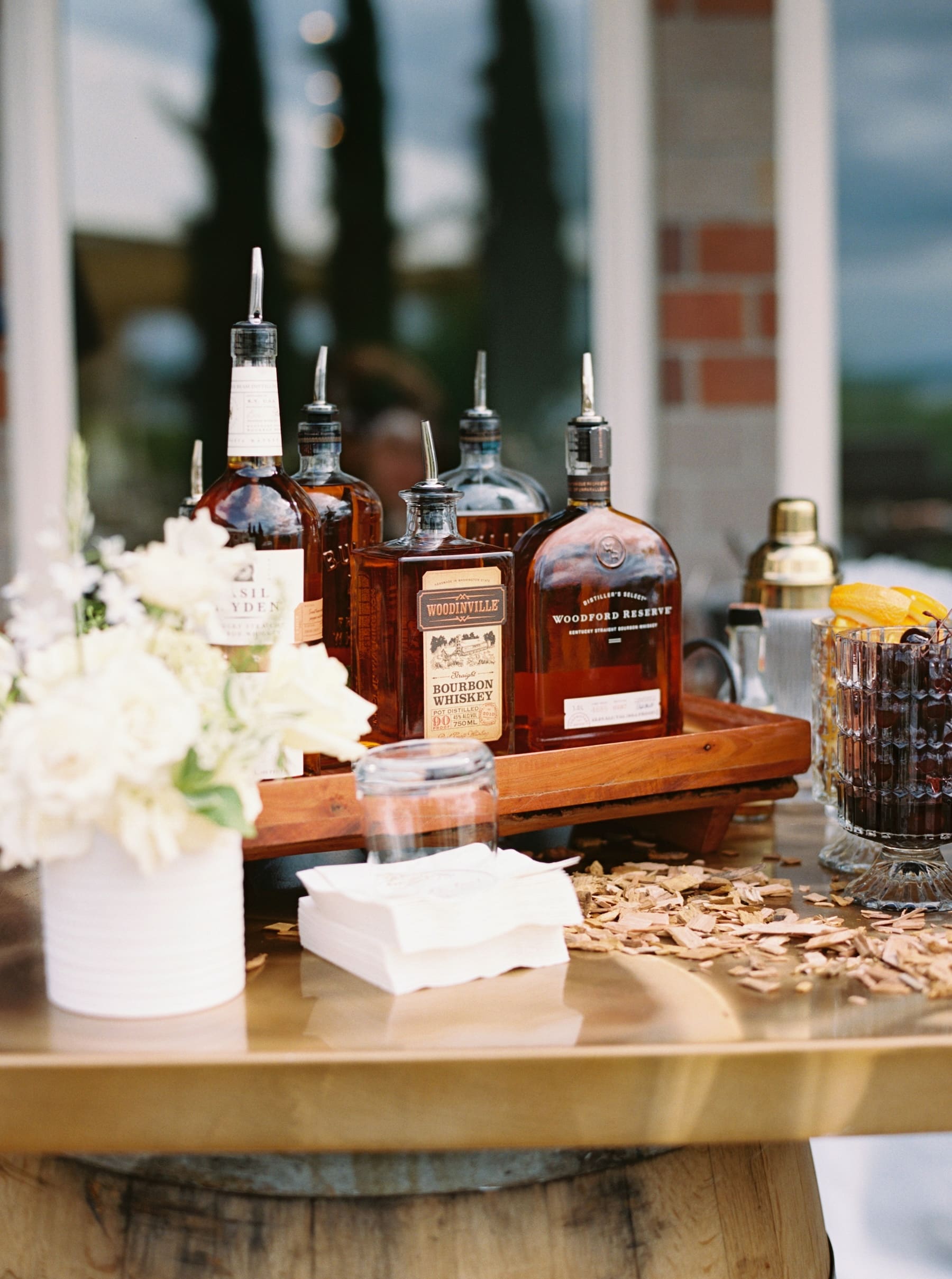 Bourbon whiskey bottles on a decorative wooden bar display