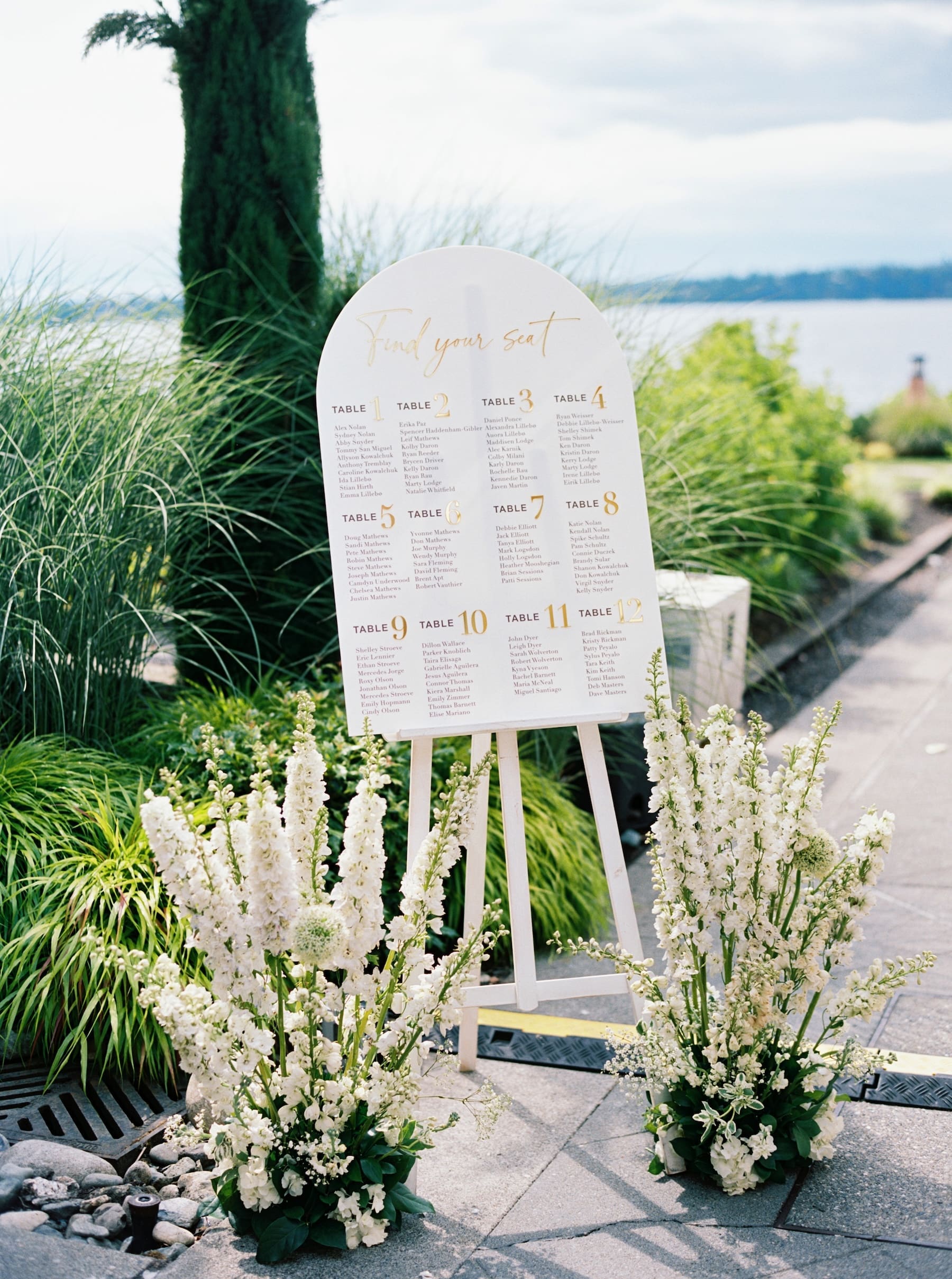 Elegant outdoor wedding seating chart with floral decor