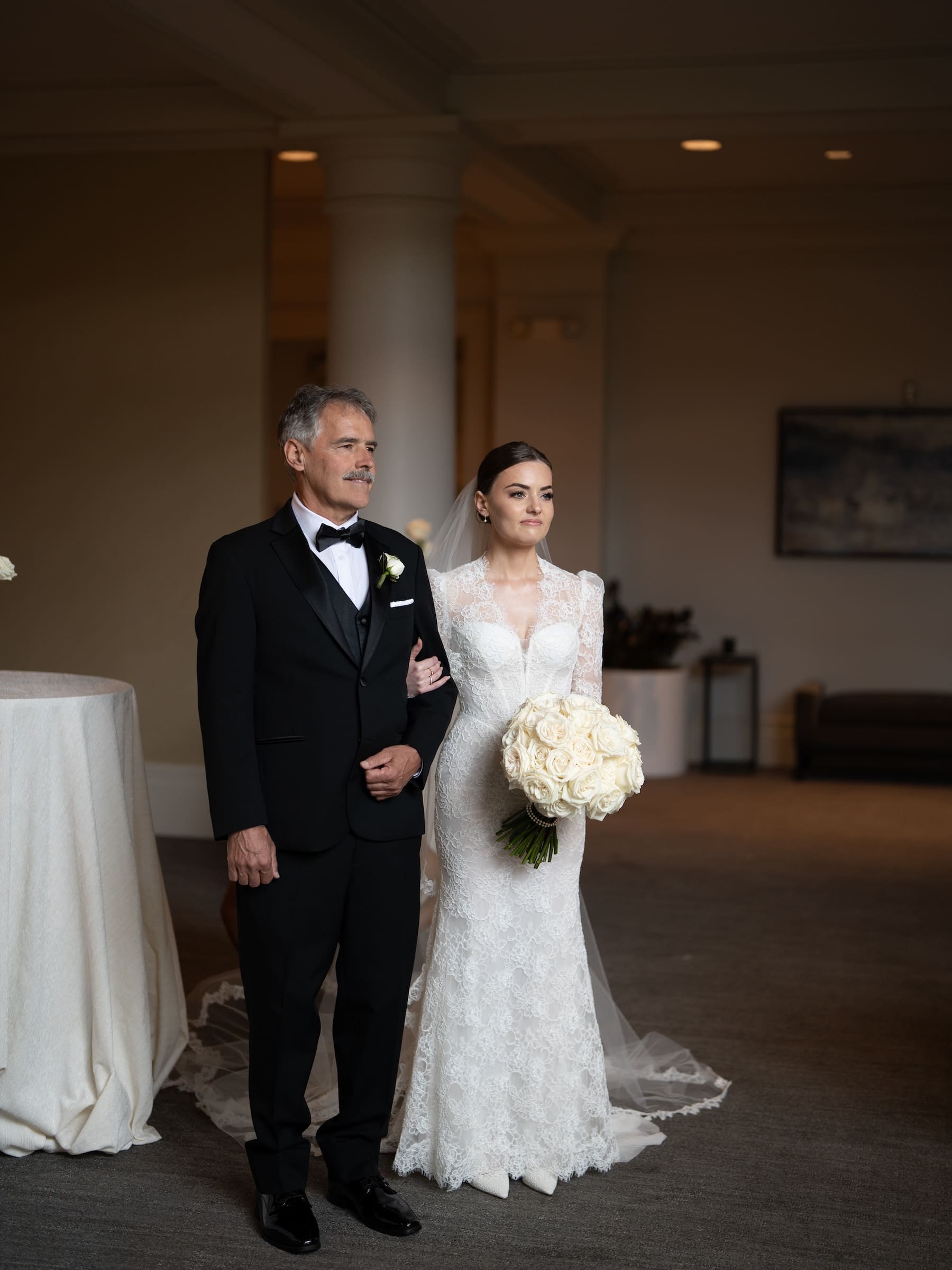 bride holding fathers arm waiting to walk down the aisle at eh Woodmark hotel 