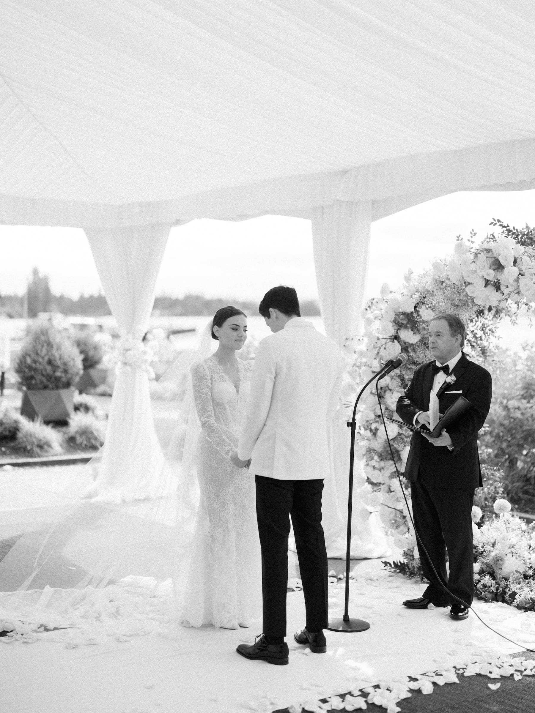 Bride and groom exchange vows at serene outdoor ceremony