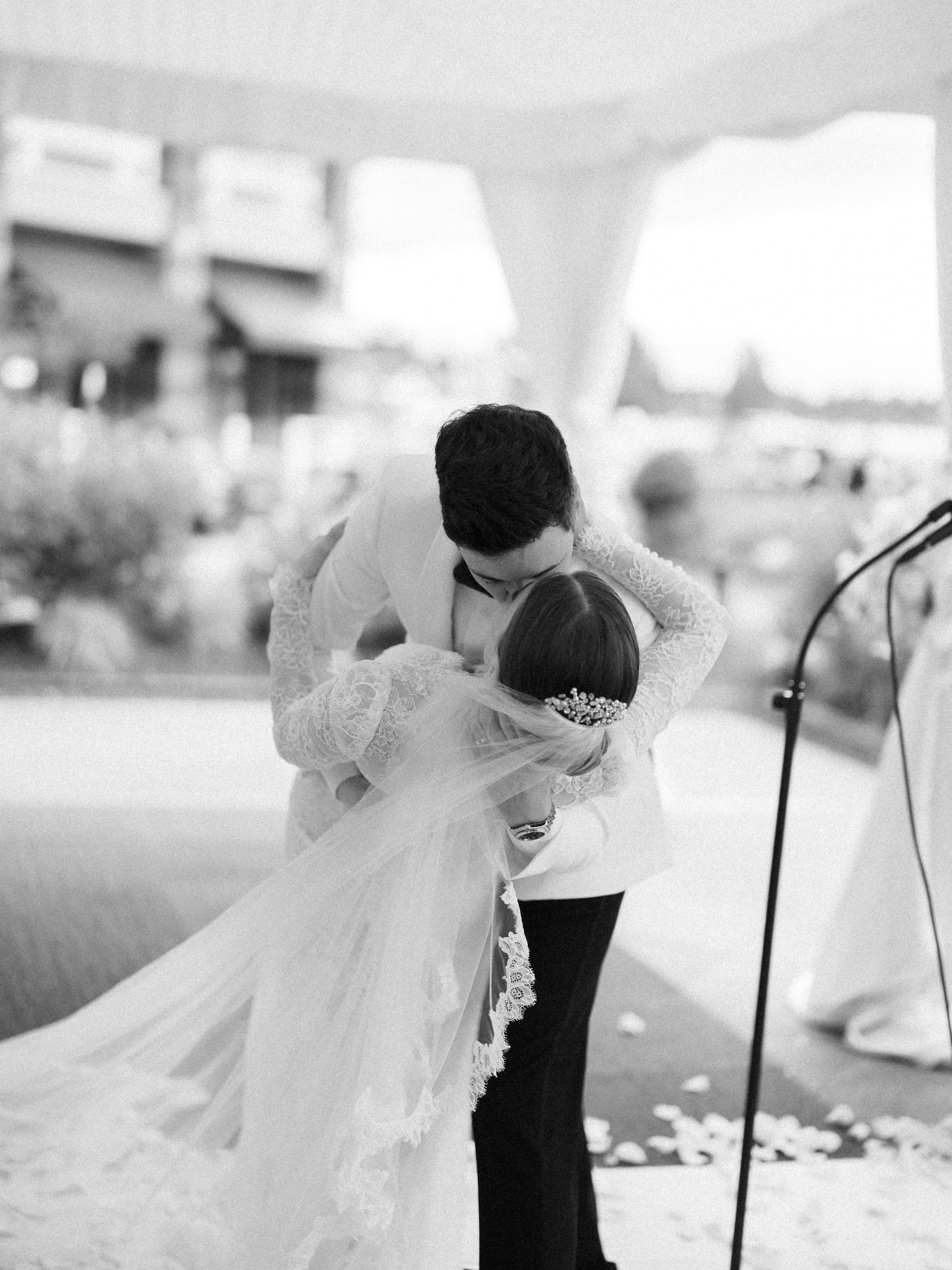 Bride and groom share a romantic wedding day kiss outdoors