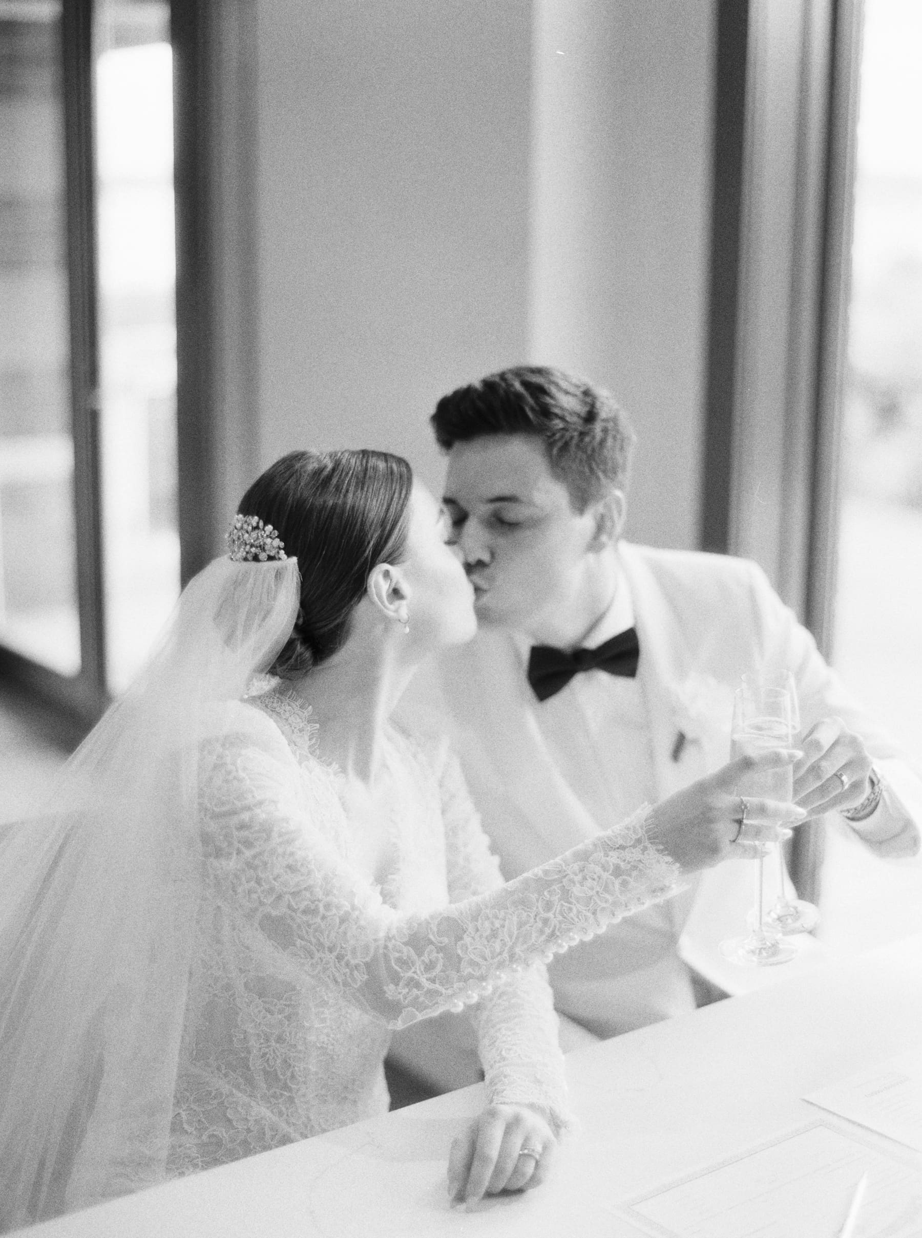Bride and groom share a romantic kiss at their wedding reception