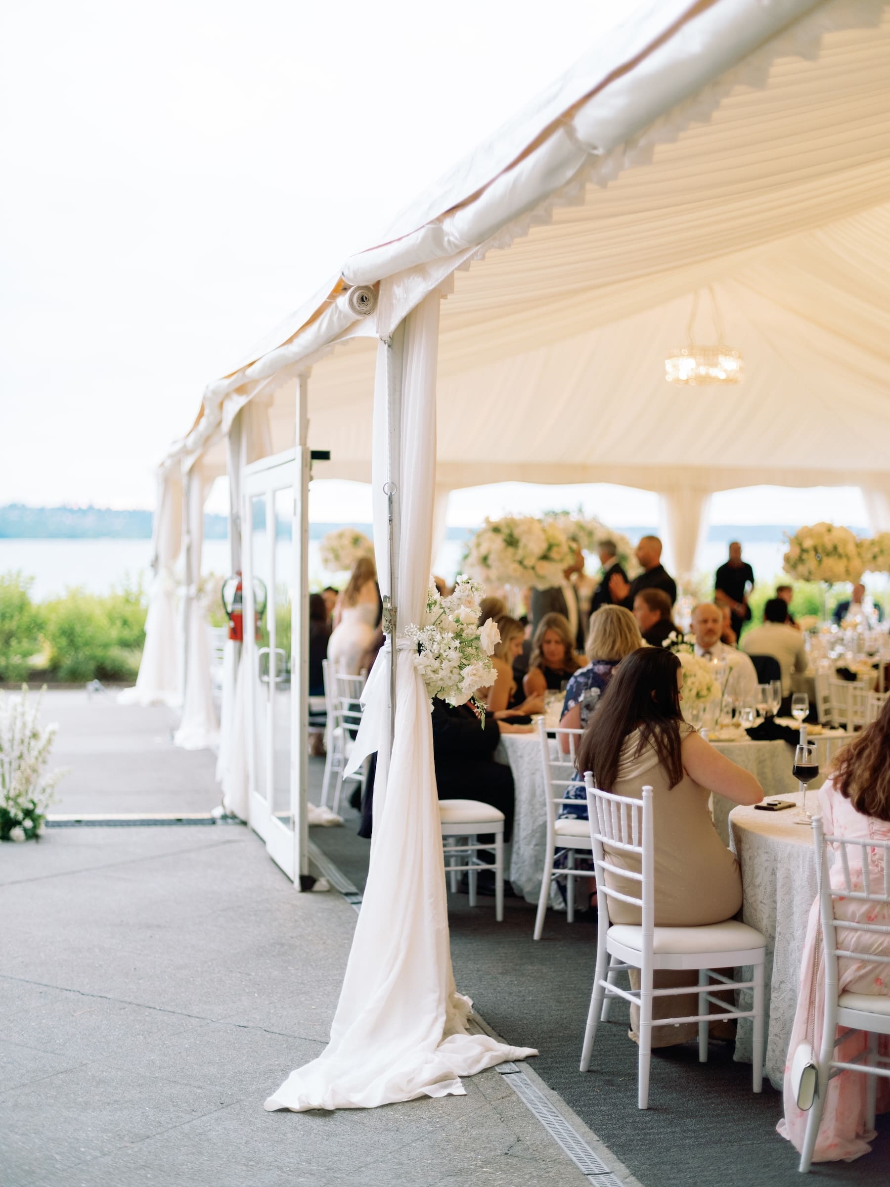 Outdoor wedding reception under elegant white tent setup