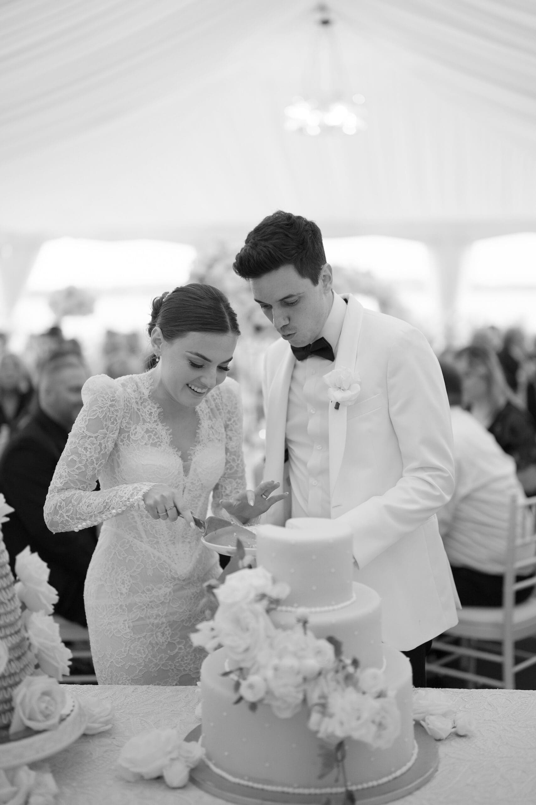 black and white image of bride and groom cutting the cake at woodmark hotel wedding
