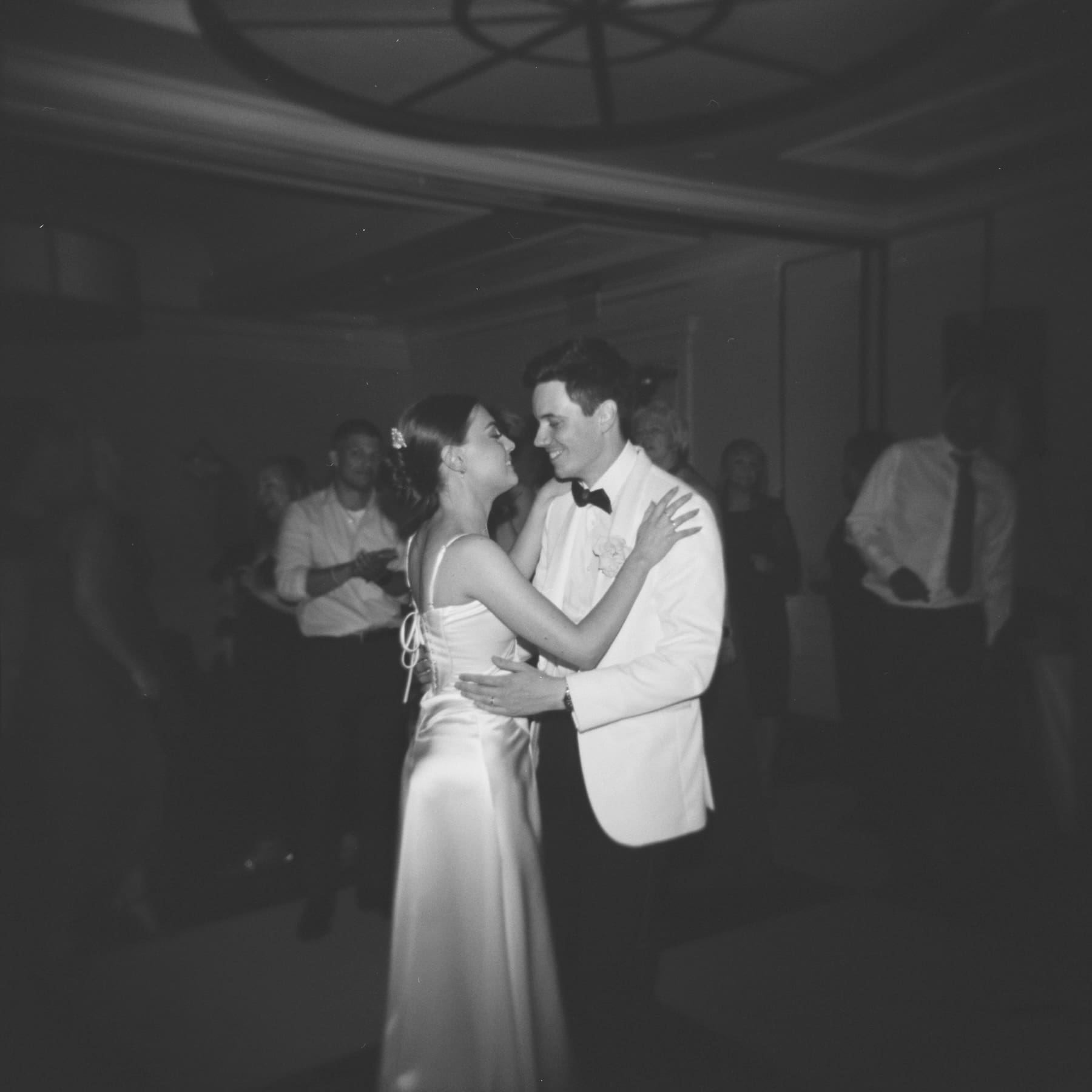 holga ilford delta 3200 black and white image of bride and groom dancing indoors in the dark