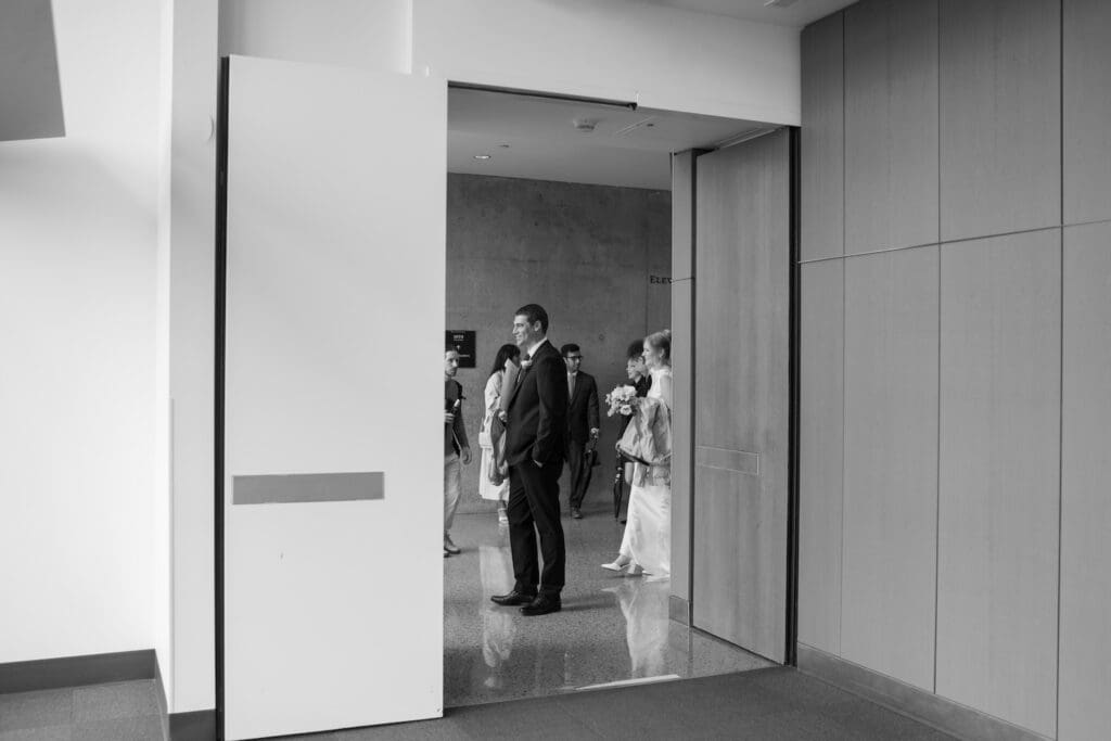 candid black and white of bride and groom waiting for their ceremony at the Seattle Courthouse 