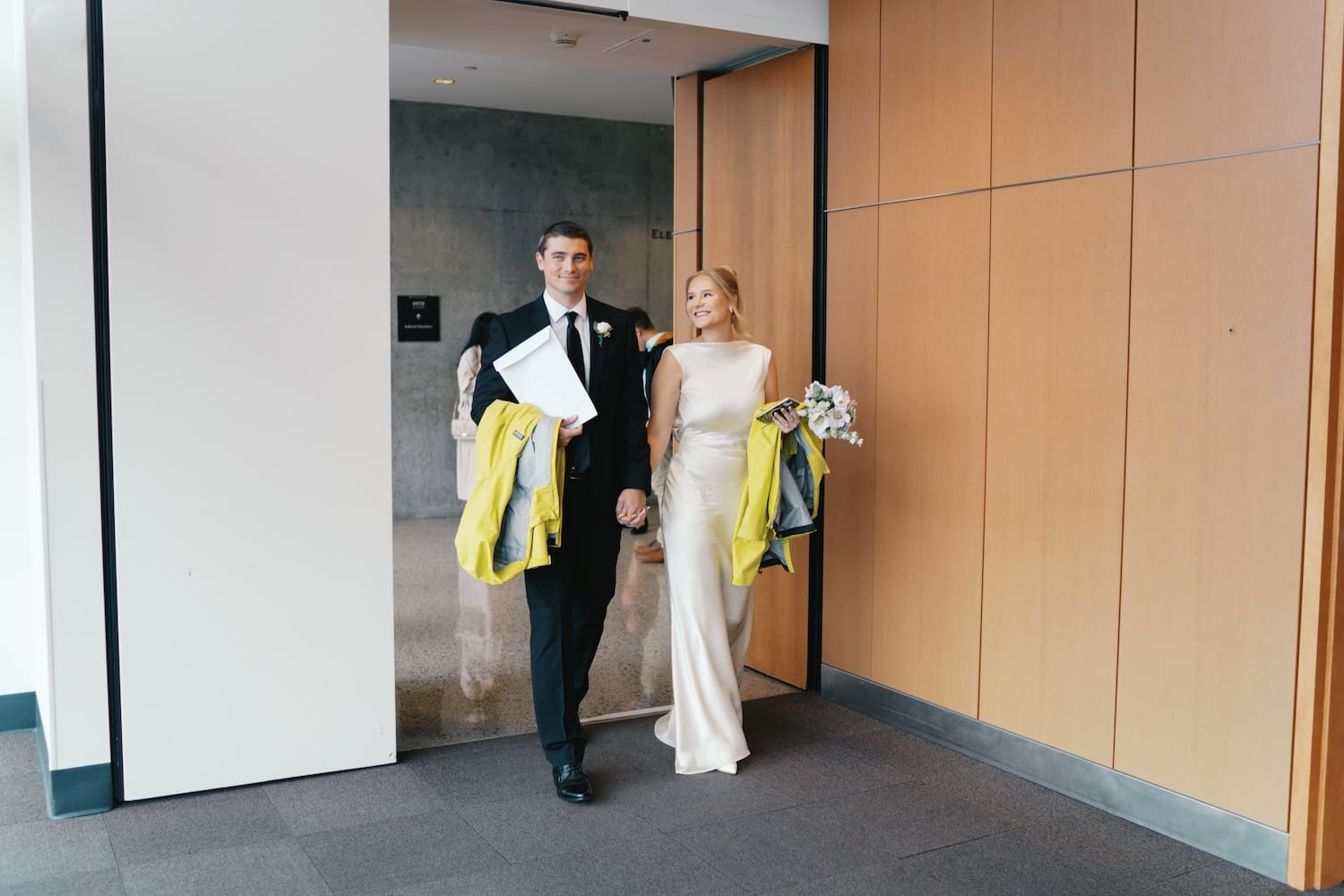 bride and groom walking around inside the seattle municipal courthouse for their elopement 